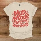 Mom Mode Brewing And Surviving Typography Coffee Natural T Shirt Unisex
